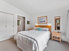 A bedroom with a bed and bedside table at Pukawa Haven - Pukawa Bay