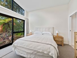 A bedroom with a bed and bedside table at Pukawa Haven - Pukawa Bay