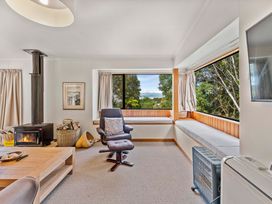 A living room with a fireplace and seating area at Pukawa Haven - Pukawa Bay