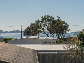 A view of rooftops and the ocean at Joes Place - Cooks Beach Holiday Home, Cooks Beach