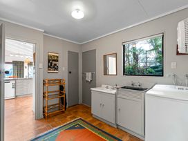 A laundry room with sink and washing machine at Ruatotara - Pukawa Holiday Home, Pukawa Bay