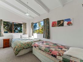 A bedroom with two beds and a window at Ruatotara - Pukawa Holiday Home Pukawa Bay