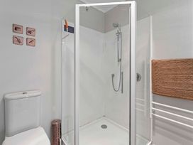 A bathroom with a shower and toilet at Ruatotara - Pukawa Holiday Home Pukawa Bay