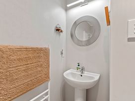 A bathroom with a sink and mirror at Ruatotara - Pukawa Holiday Home Pukawa Bay