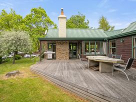 An outdoor area with a deck and seating at Tranquil Tipperary - Arrowtown Holiday Home in Arrowtown