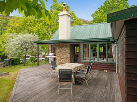 An outdoor area with a table and chairs at Tranquil Tipperary - Arrowtown Holiday Home in Arrowtown
