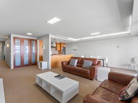 A living room with a sofa and coffee table at Taupo Vista - Taupo Central