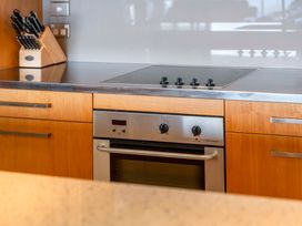 A kitchen with an oven and stove at Taupo Vista - Taupo Apartment in Taupo Central