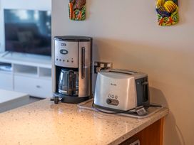 A coffee maker and a toaster on a kitchen counter at Taupo Vista - Taupo Central