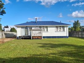 A house with a deck and yard at Snowed Inn - Ohakune
