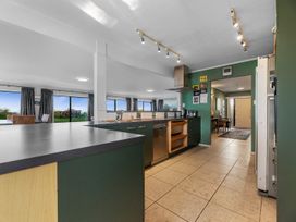 A kitchen featuring a counter and appliances at Beach Galore - Waihi Beach