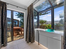 A room with a window and a table at Beach Galore - Waihi Beach Holiday Home Waihi Beach