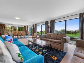 A living room with a sofa and coffee table at Beach Galore - Waihi Beach