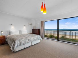 A bedroom with a view of the ocean at Beach Galore - Waihi Beach