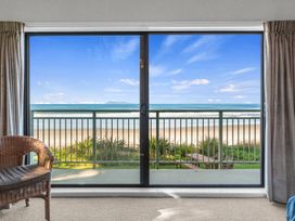 A view from a window showing a beach scene at Beach Galore - Waihi Beach
