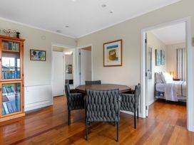 A dining area with a table and chairs at Beach Galore - Waihi Beach