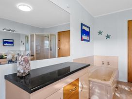 A bathroom with a bathtub and shower at Beach Galore - Waihi Beach Holiday Home Waihi Beach