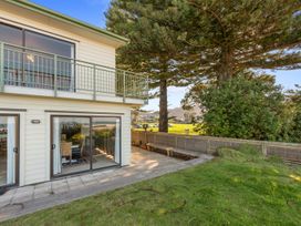 An outdoor view of the building and surrounding trees at Beach Galore - Waihi Beach