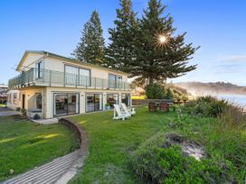 A house with a deck and balcony in an outdoor area at Beach Galore - Waihi Beach