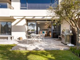 An outdoor area with a table and chairs at The Sandcastle - Papamoa Holiday Apartment in Papamoa