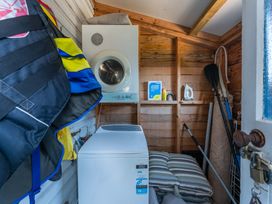 A laundry room with a washing machine and dryer at Kingfisher - Kuratau Holiday Home in Kuratau