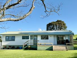 A house with a deck and windows at Waihi Getaway - Waihi Beach