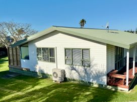 A house with a garden and deck at Waihi Getaway - Waihi Beach