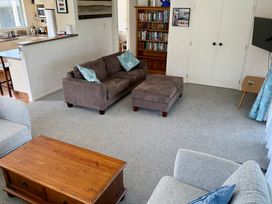 A living room with a sofa and coffee table at Waihi Getaway - Waihi Beach