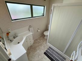 A bathroom with a sink, toilet and shower at Waihi Getaway - Waihi Beach