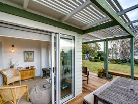 An outdoor living area with seating and a table at Jacaranda Lodge - Napier Hill Holiday Home in Bluff Hill