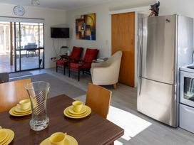 A dining room with a table set for tea at Ronas - Whiritoa Beach Bach in Whiritoa Beach