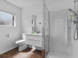 A bathroom with a shower and sink at Ruakaka Sands - Ruakaka