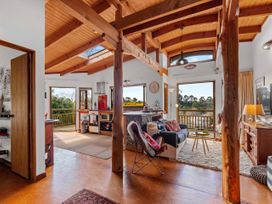 A living room with a sofa and coffee table at Treetop Hideaway - Taupo Holiday Home Taupo Central