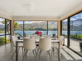 A dining room with a lake view at Lakeside Serenity - Wanaka Holiday Home in Wanaka