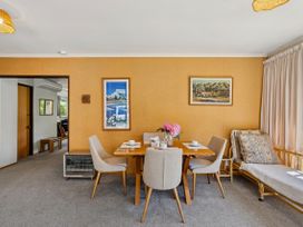 A dining room with a table and chairs at Lakeside Serenity - Wanaka Holiday Home Wanaka