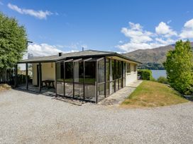 An outdoor view of a house near a lake at Lakeside Serenity - Wanaka Holiday Home Wanaka