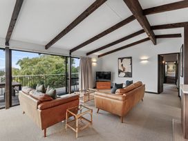 A living room with sofas and a television at Acacia View at No. 3 - Acacia Bay