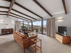 A living room with a sofa and television at Acacia View at No. 3 - Acacia Bay