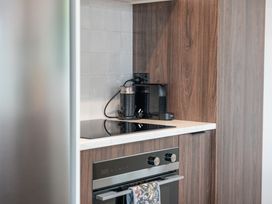 A kitchen with an oven and coffee machine at Acacia View at No. 3 - Acacia Bay