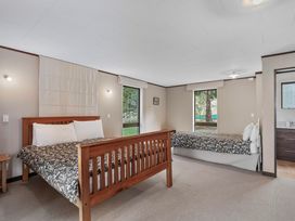 A bedroom with two beds and a window at Acacia View at No. 3 - Acacia Bay