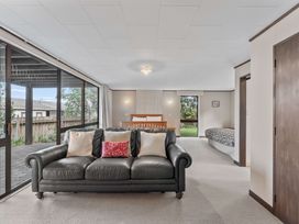 A living room with a sofa and a bed at Acacia View at No. 3 - Acacia Bay