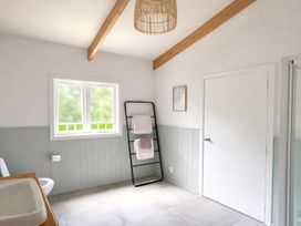 A bathroom with a sink, toilet, and towel rack at Matapouri Hideaway - Matapouri