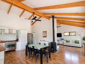 A kitchen with dining area and living space at Matapouri Hideaway - Matapouri