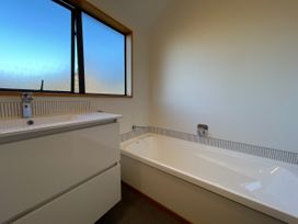 A bathroom with a sink and bathtub at Wanaka Tranquility - Wanaka