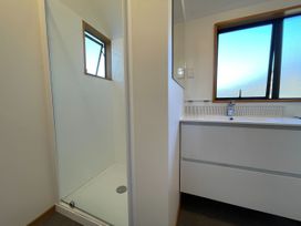 A bathroom with a sink and a shower at Wanaka Tranquility - Wanaka