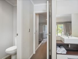 A bathroom with a toilet and sink at Putt it at Pauanui - Pauanui