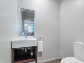A bathroom with a sink and toilet at Putt it at Pauanui - Pauanui