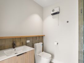 A bathroom with a wash basin and toilet at Brow Peak View - Arrowtown Holiday Home