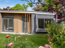 A house with large windows and a garden at Brow Peak View - Arrowtown Holiday Home, Arrowtown