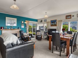 A living room with furniture and decorations at Raisin Town - Marahau Bach, Marahau
